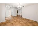 Open living space featuring neutral paint, tiled floors and classic light fixture at 13420 Copper Head Dr, Riverview, FL 33569