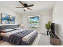 This light-filled bedroom boasts a modern design, with ceiling fan, and stylish decor at 13622 Tramore Dr, Odessa, FL 33556