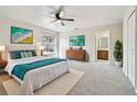 Bright main bedroom featuring a ceiling fan, neutral tones, and ensuite bathroom access at 13622 Tramore Dr, Odessa, FL 33556