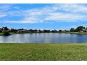 A beautiful expansive lake view behind a well-manicured lawn at 16261 Amethyst Key Dr, Wimauma, FL 33598