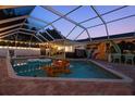 Wonderful screened-in pool area with outdoor decor and mural for leisure and entertainment at 1698 Eden Ct, Clearwater, FL 33756