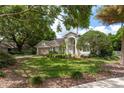 Beautiful home with large lawn, mature landscaping, and a charming exterior, perfect for Gathering living at 18106 Woodcreek Pl, Lutz, FL 33548