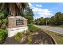 Briar Oaks brick community sign surrounded by lush landscaping along a paved road on a sunny day at 18314 Waydale Loop, Hudson, FL 34667