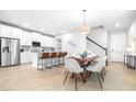 Bright, open floor plan featuring a modern kitchen and dining area with ample seating at 19195 Blue Pond Dr, Lutz, FL 33558