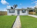 Charming single story home with a well maintained lawn, freshly painted exterior, and carport at 21042 Gladis Ave, Port Charlotte, FL 33952