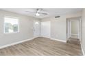 Bright living room featuring stylish plank floors, ceiling fan, and neutral paint at 21042 Gladis Ave, Port Charlotte, FL 33952