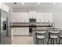 Modern kitchen featuring stainless steel appliances, granite countertops, and white cabinetry at 2835 Hilliard Dr, Wesley Chapel, FL 33543