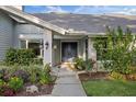 Elegant front door with colorful landscaping, providing a welcoming entryway at 2969 Talon Dr, Clearwater, FL 33761