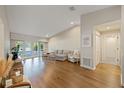 Spacious living room featuring hardwood floors, neutral paint and lots of natural light at 2969 Talon Dr, Clearwater, FL 33761