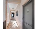 Outdoor hallway with a view of the beach at the end, and a condo entrance on the right at 3210 Gulf Blvd # 108, Belleair Beach, FL 33786