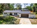 Charming single-story home featuring a neatly landscaped front yard and attached garage at 3225 Bea Ct, Land O Lakes, FL 34639
