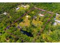 Expansive property featuring lush greenery, mature trees and a pond, enclosed by a bright pink line at 3226 Palmetto Rd, Wimauma, FL 33598
