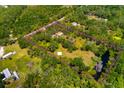 Expansive property featuring lush greenery, mature trees and a pond, enclosed by a bright pink line at 3226 Palmetto Rd, Wimauma, FL 33598