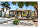 Charming home features a gray exterior, yellow shutters, and a landscaped yard at 3228 7Th N Ave, St Petersburg, FL 33713