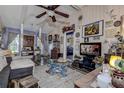 Cozy living room with wood-look floors, vaulted ceilings, and decoratively adorned walls at 3721 140Th Ave, Largo, FL 33771