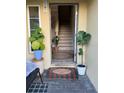 Inviting entryway with tiled floors, indoor plants, a welcome mat, and staircase at 4053 Rocky Shores Dr, Tampa, FL 33634