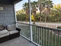 Relaxing screened patio with comfortable seating and a view of lush greenery and palm trees at 4053 Rocky Shores Dr, Tampa, FL 33634