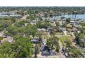 Expansive aerial view showcases the neighborhood, lake, surrounding trees, and the home's location at 419 40Th S Ave, St Petersburg, FL 33705