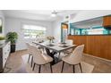 Dining area with a modern table, seating for six, and ample natural light at 4732 W Wyoming Ave, Tampa, FL 33616