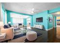 Bright living room featuring modern decor, dark wood floors and stylish furniture at 4732 W Wyoming Ave, Tampa, FL 33616