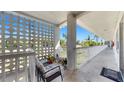 Hallway exterior patio with outside furniture overlooking landscaped grounds and blue skies at 5150 10Th N Ave # 310A, St Petersburg, FL 33710