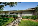 Charming home exterior with well-maintained landscaping, a picket fence, and a welcoming front porch at 70 Ashley Ln, Oldsmar, FL 34677