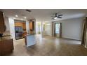 Open floor plan with tile flooring, view to kitchen, and ample natural light from large windows at 7530 Red Mill Cir, New Port Richey, FL 34653