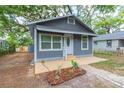 Quaint grey home with a welcoming front porch and simple landscaping at 8008 N Alaska St, Tampa, FL 33604