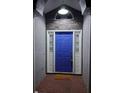 Inviting entryway with a bright blue front door, decorative transom window, and textured walls at 824 Greenbelt Cir, Brandon, FL 33510