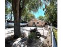 Exterior view with a motorcycle, boat, and outdoor seating on a brick-paved area, perfect for outdoor living at 8516 N Dixon Ave, Tampa, FL 33604