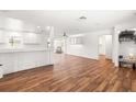 Bright and airy living space features wood-look flooring, white walls and trim, and an open floor plan at 8801 Gulf Blvd, St Petersburg, FL 33706