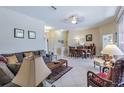 Comfortable living room and dining area offers an open floor plan and neutral colors at 965 Westwinds Blvd, Tarpon Springs, FL 34689