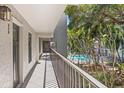 Balcony with a view of lush greenery and a sparkling pool area at 105 4Th Ne Ave # 219, St Petersburg, FL 33701