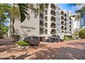 Condo building featuring a covered parking area, well maintained landscaping, and multiple balconies at 105 4Th Ne Ave # 219, St Petersburg, FL 33701
