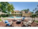 Spacious backyard featuring a pool, patio with outdoor seating, and a fire pit at 10600 Indian Hills Ct, Seminole, FL 33777