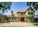 Charming two-story home with a stone facade, mature trees, and a welcoming entrance at 10600 Indian Hills Ct, Seminole, FL 33777