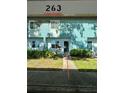 Condominium exterior featuring private entrance, garden and clearly marked car port at 11432 Bay Ne St # 11432, St Petersburg, FL 33716