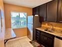 Kitchen features stainless steel refrigerator and granite countertops at 11432 Bay Ne St # 11432, St Petersburg, FL 33716