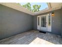 Inviting front entryway featuring a tiled patio and a stylish white front door with glass detailing at 12536 116Th St, Largo, FL 33778