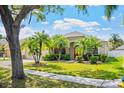 Beautiful single-story home featuring lush landscaping and a well-maintained green lawn at 1418 Hurley Pond Ln, Valrico, FL 33596