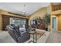 Comfortable living room with vaulted ceilings, a ceiling fan and an entertainment center at 17364 Mediterranean Cir, Weeki Wachee, FL 34614