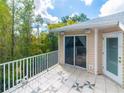 Balcony with sliding glass doors overlooking wooded landscape at 1746 Heron Cove Dr # 1746, Lutz, FL 33549