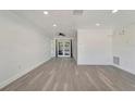 Bright living room with recessed lighting, crown molding, and French doors at 1968 Rolling Green Cir, Sarasota, FL 34240