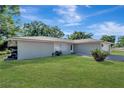 Single-story home with a well-maintained lawn at 1968 Rolling Green Cir, Sarasota, FL 34240