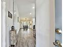 Inviting condo interior with a hardwood hallway leading to the dining and living room with recessed lighting at 2291 Americus W Blvd # 41, Clearwater, FL 33763