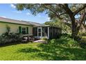Relaxing backyard with a screened lanai, mature trees, and lush greenery for outdoor enjoyment at 3204 40Th S Way # B, St Petersburg, FL 33711