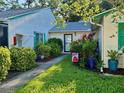 Charming single-story villa with lush landscaping and a cozy front entrance with beautiful plants at 3204 40Th S Way # B, St Petersburg, FL 33711