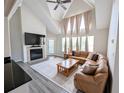 Comfortable living room featuring a fireplace, vaulted ceilings and a leather sofa at 3305 Haviland Ct # 301, Palm Harbor, FL 34684
