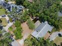 Overhead shot of the property showing lush greenery, a pond, and the roof's layout at 4315 W Azeele St, Tampa, FL 33609