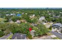 Aerial shot of a home within a leafy residential neighborhood near the water and city skyline at 5001 W Dickens Ave, Tampa, FL 33629